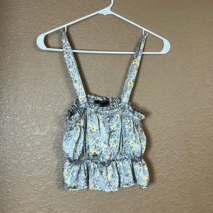 Small satin cropped tank top, gray background, and yellow flowers